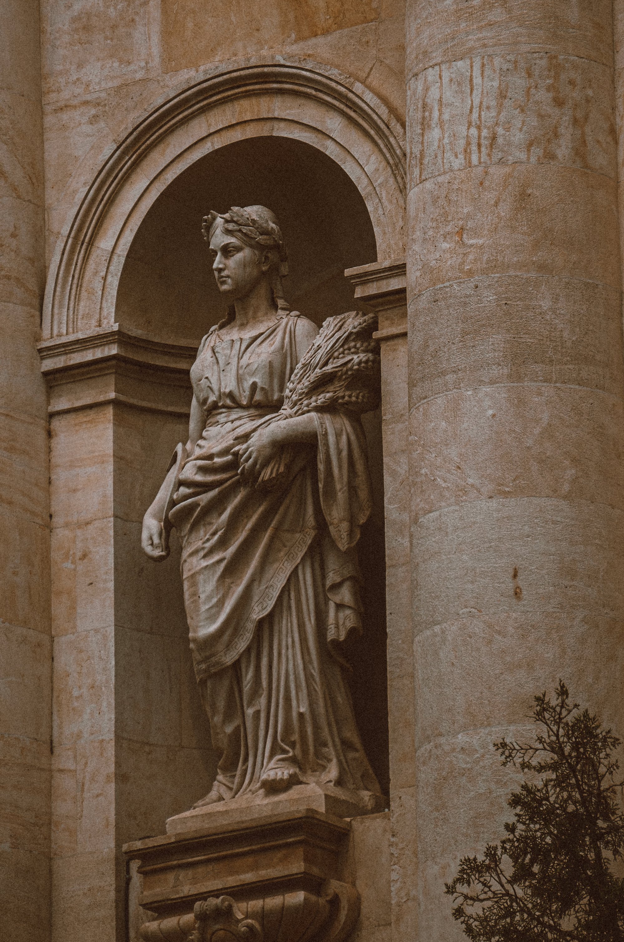 Ancient Greek Statue on the Facade of a Building