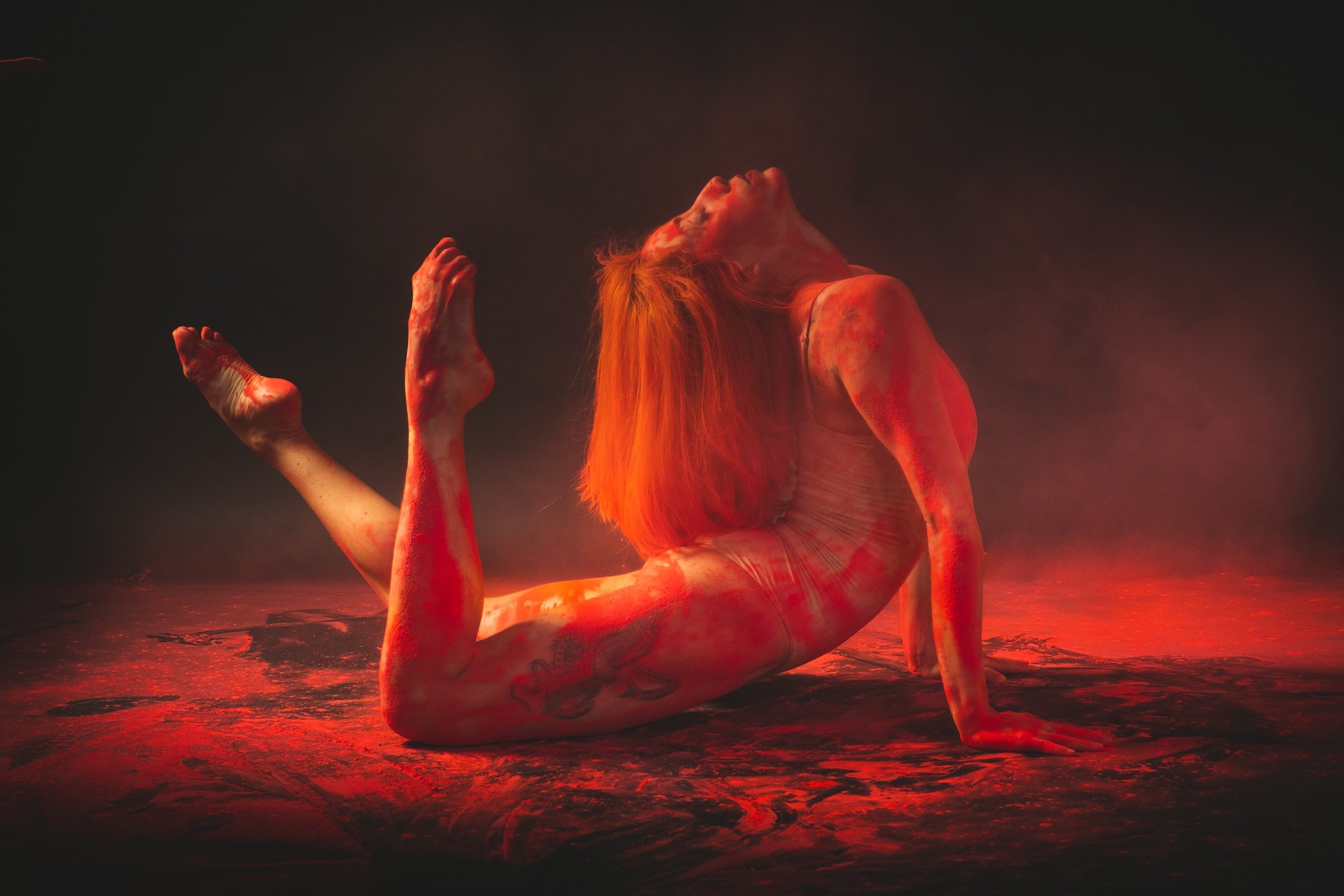 A Woman Bending Her Body while Lying on the Floor